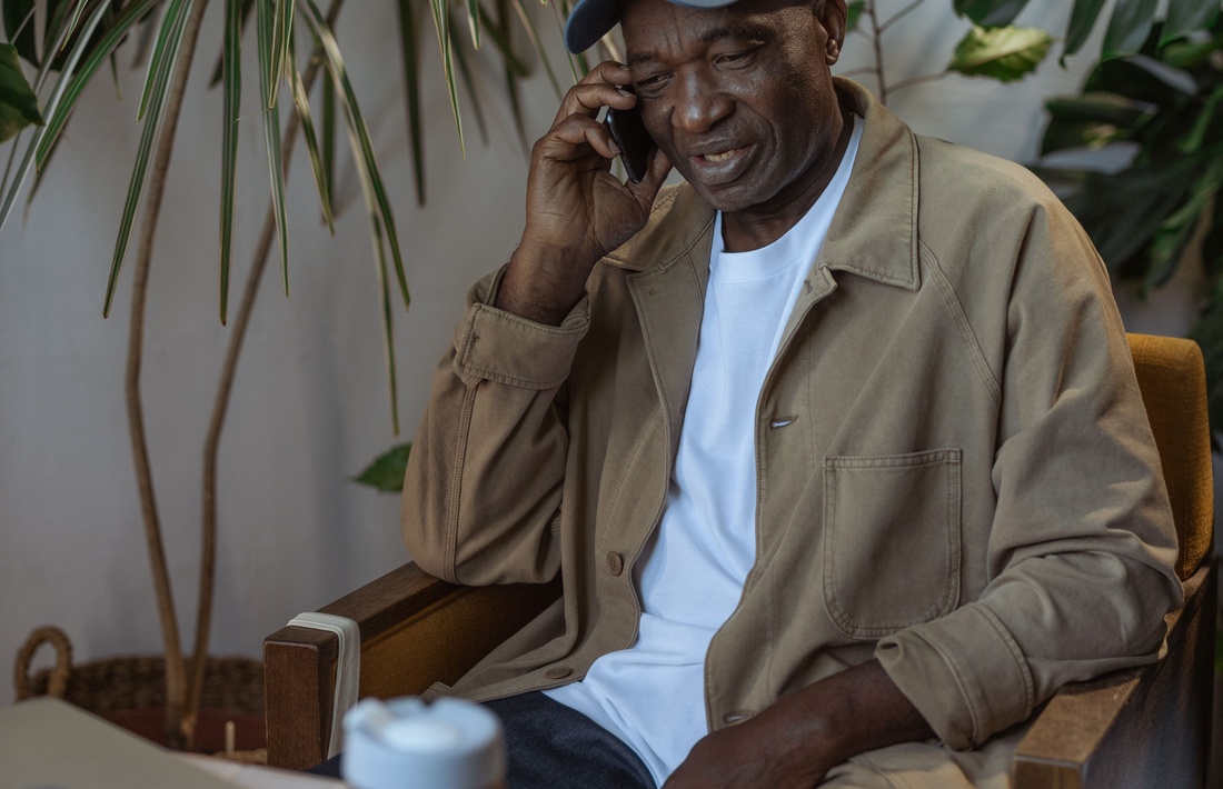 Older man enjoying a phone conversation at home