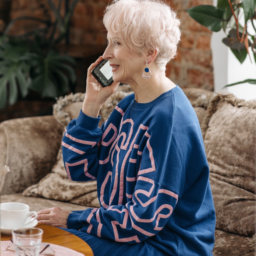 Older woman smiling while speaking on the phone